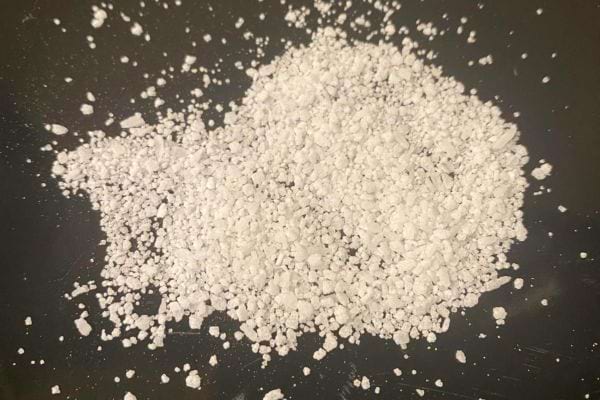 Gros sel éparpillé sur fond noir, utilisé pour la protection domestique.