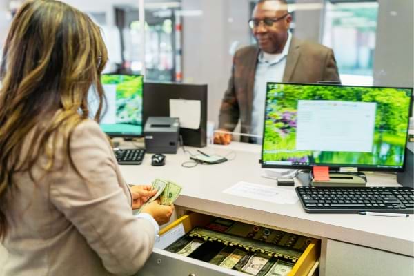 Une personne qui retire de l'argent en mandat cash