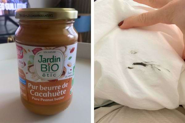 Beurre de cacahuète et tache noire sur tissu blanc.