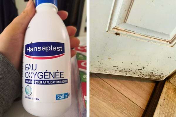 Une main tenant une bouteille d'eau oxygénée près d'une porte tachée.