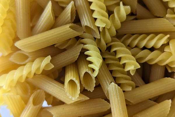 Zoom sur un assortiment de pâtes sèches montrant différentes formes et textures.