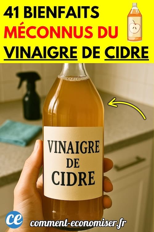 Une main tenant une bouteille de vinaigre de cidre dans une cuisine.