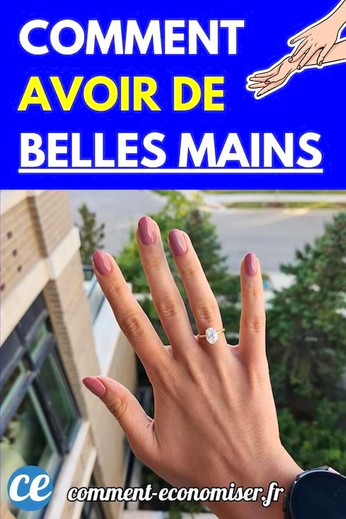 Une main avec des ongles manucurés tenue à l’extérieur devant un paysage urbain flou.
