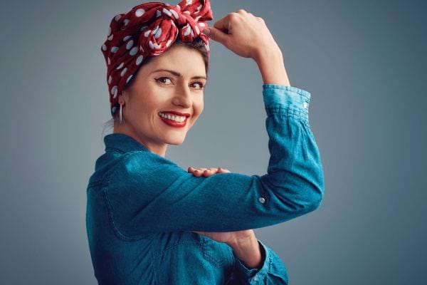 Femme forte pose en geste de puissance.