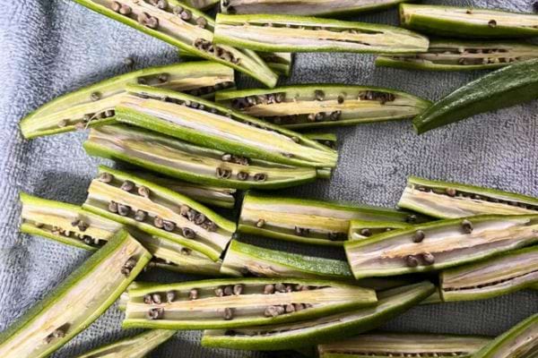 Gombos ouverts en deux laissant voir les graines.