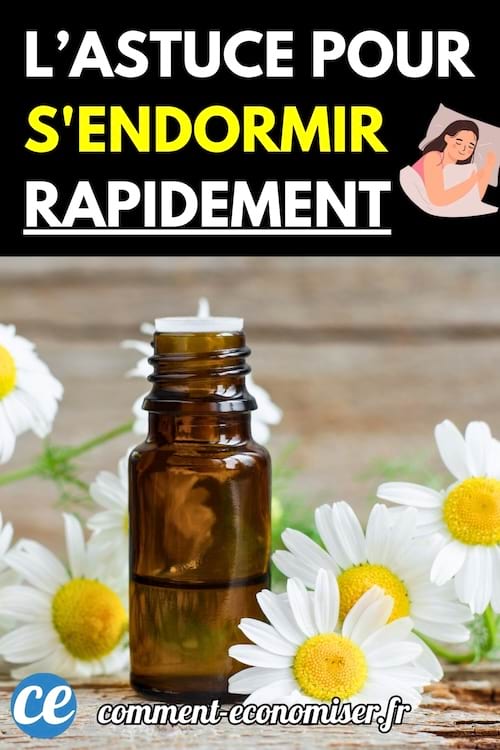 Flacon d’huile essentielle entouré de fleurs de camomille.