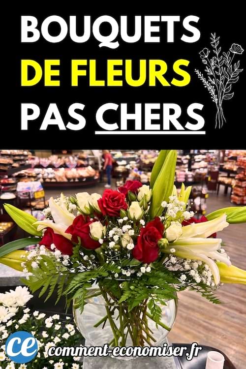 Un bouquet de fleurs colorées avec des roses rouges et des lys blancs posé sur un comptoir de magasin.