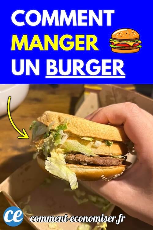 Un hamburger à l'envers tenu à la main, prêt à être mangé.