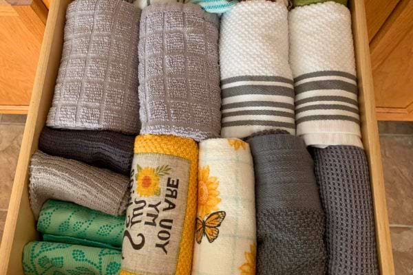 Tiroir bien rangé avec torchons roulés.