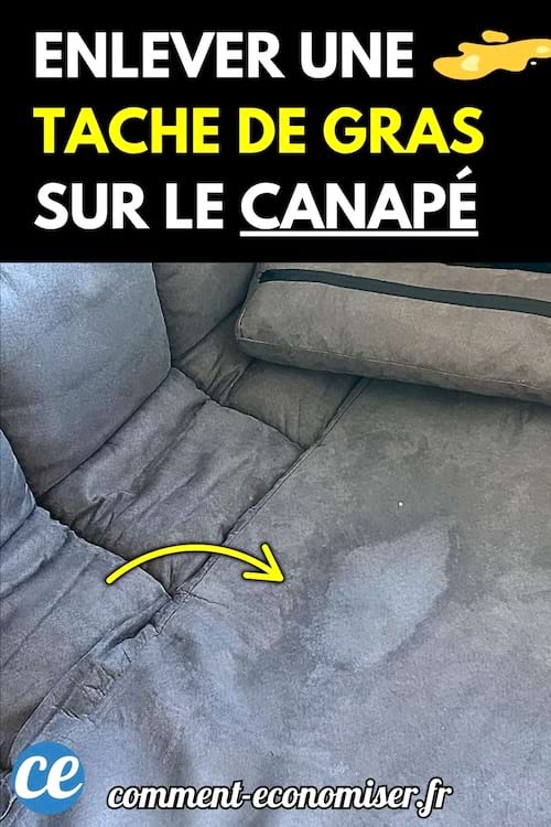Une tache de graisse visible sur un canapé en tissu gris foncé.