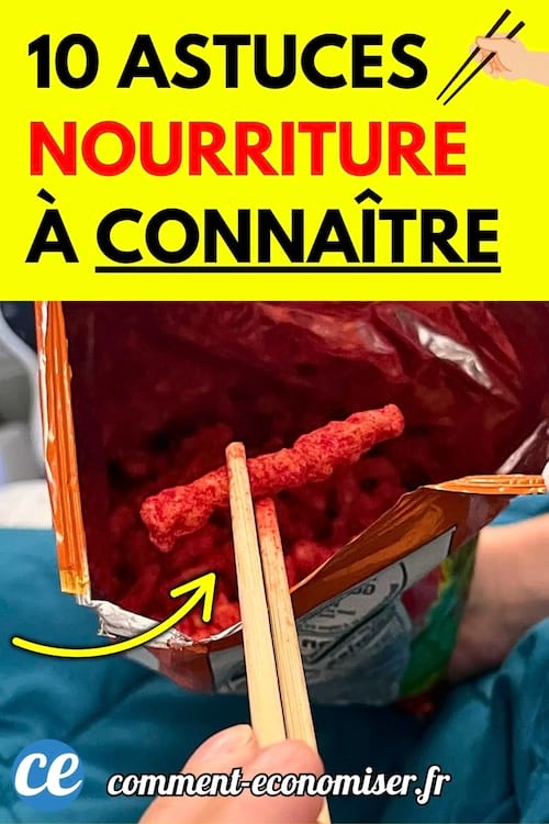 Main tenant des baguettes pour attraper un snack rouge dans un sachet ouvert posé sur les genoux.