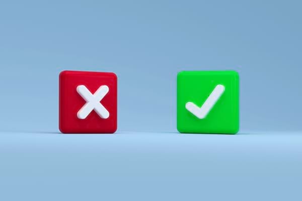 Deux cubes : un rouge avec une croix et un vert avec une coche, sur fond bleu.