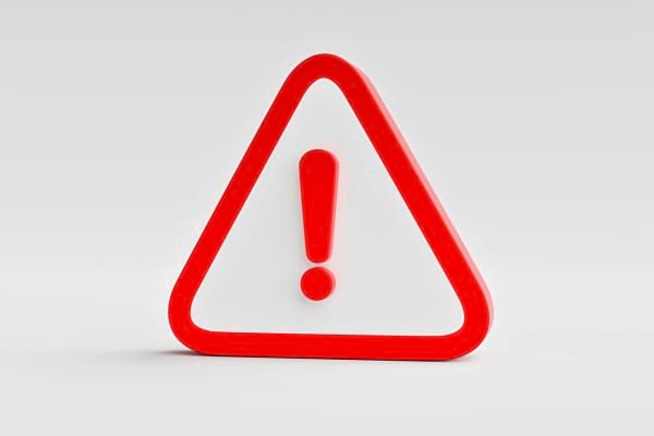 Panneau d'avertissement rouge avec un point d'exclamation sur fond blanc.