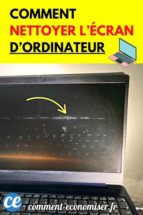 Un ordinateur portable noir avec un écran sale marqué de traces blanches.