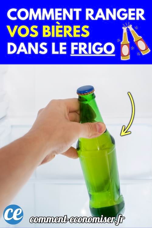 Une main qui range une bouteille de bière dans le frigo