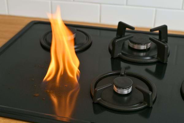 Flamme allumée sur une plaque de cuisson.