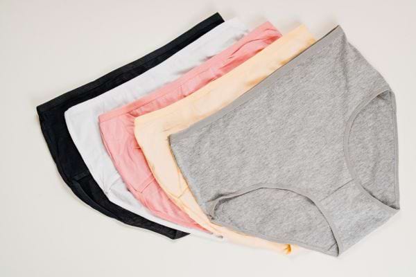 Un lot de culottes en coton colorées est posé à plat.