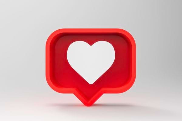 Un symbole de cœur blanc dans une bulle rouge de réseau social.