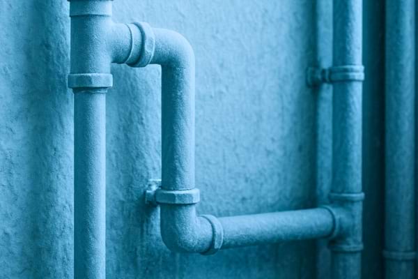 Tuyauterie d’une maison givrée avec une fine couche de glace,