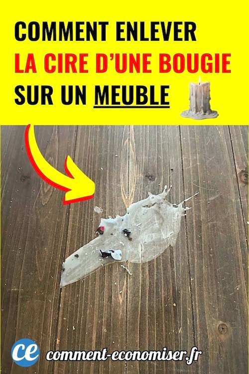Cire de bougie blanche collée sur un meuble en bois foncé.