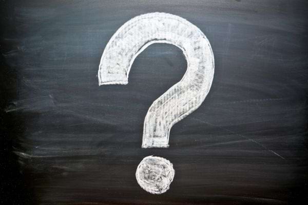 Grand point d’interrogation dessiné à la craie sur un tableau noir.