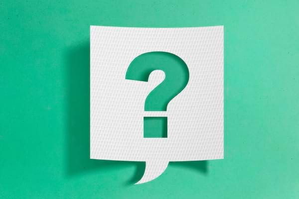 Un papier blanc découpé en forme de point d’interrogation.