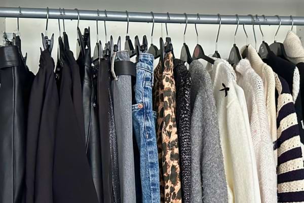 des vêtements rangés sur des cintres qui sont accrochés de différentes manières