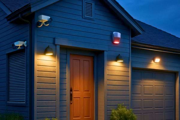 Une maison equipee de cameras et lumieres de securite brillantes au crepuscule.