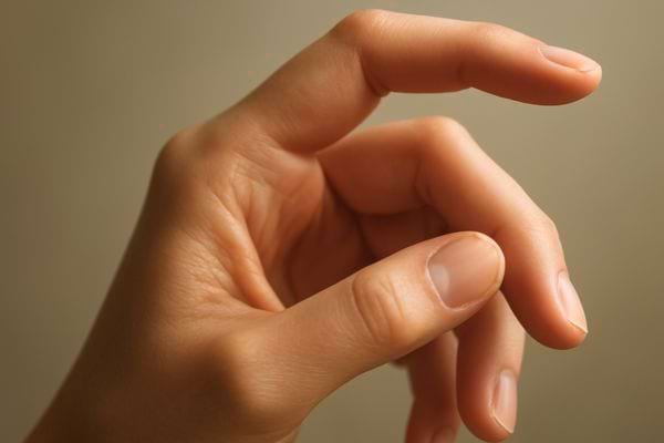 Main effectuant un geste fin, doigts courbes, posture precise et elegante.