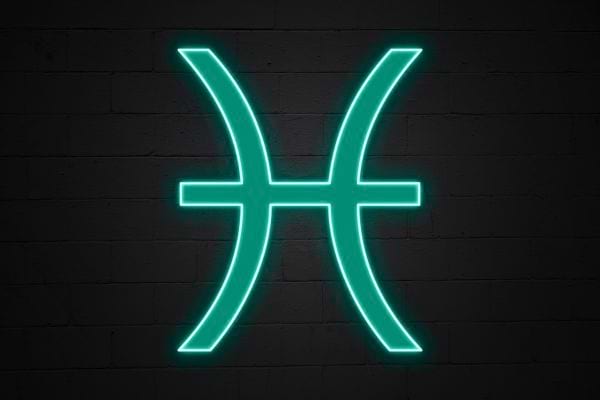 Le symbole des poissons brille en neon vert sur un mur sombre. Il represente sensibilite et intuition.