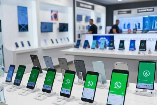 Modern refurbished smartphones displayed in electronics store, price tags visible,