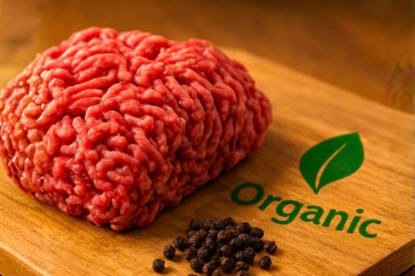 raw ground beef on a wooden cutting board, looking very fresh and high quality