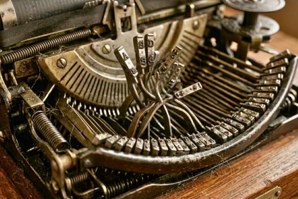 metal typewriter hammers tangled and jammed together, vintage mechanical parts