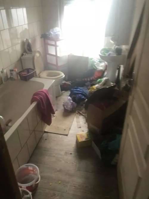 une salle de bain sale en désordre pleine de déchets