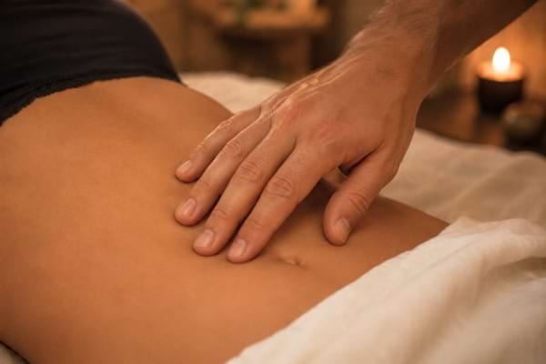 fingertips gently tracing circles on a woman's bare stomach