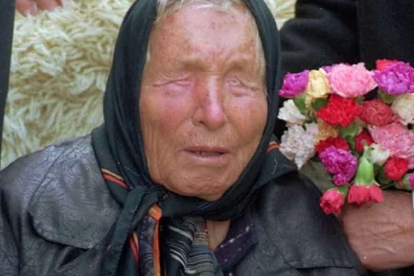 portrait de baba vanga devant une couverture et un bouquet de fleurs