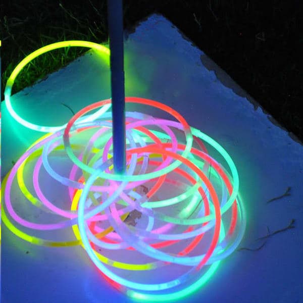 Idée pas chère et facile d'aménagement de jardin : utiliser des bâtons lumineux pour jouer au lancer d'anneaux.