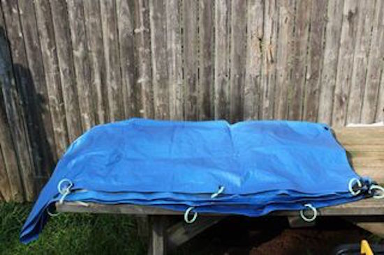 With simple curtain rings, you can turn your plastic tarp into a shower curtain!