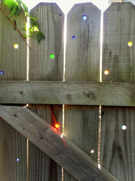 put colored marbles in the holes of the fence