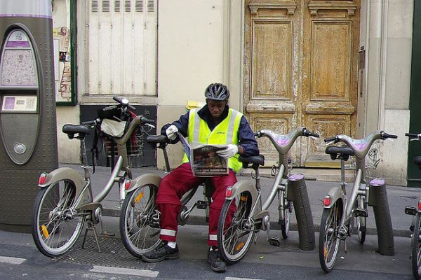 R&eacute;parateur JC Decaux assis sur une borne en pause