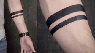 Que Signifie le Tatouage Minimaliste à Bandes Noires sur l'Avant-Bras